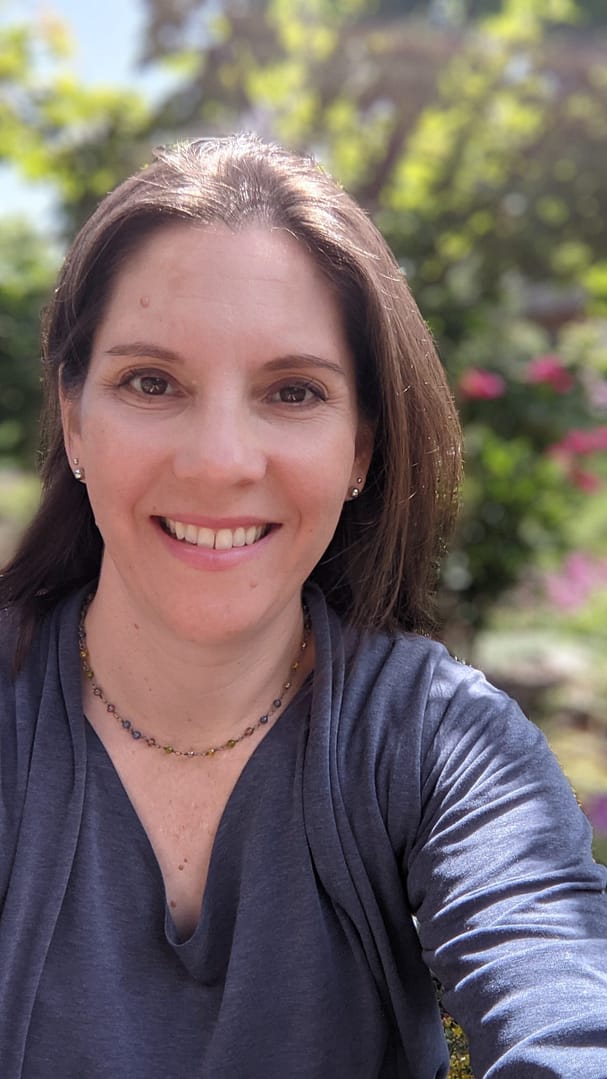 Stephanie takes a selfie in a sunny spot
